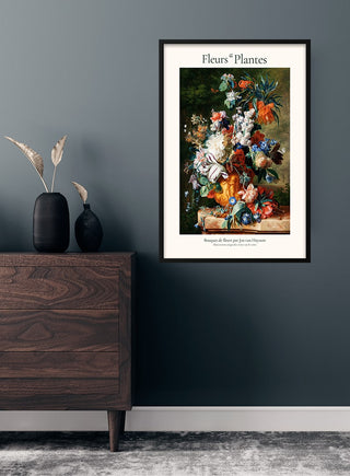 Framed print of "Bouquet of Flowers by Jan van Huysum" hanging on a dark teal wall above a wooden dresser.