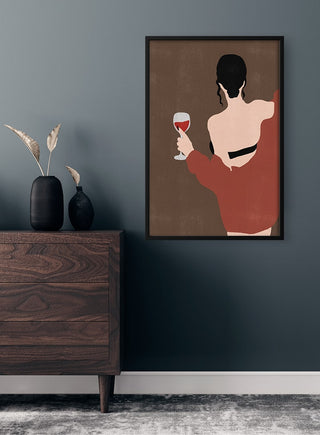Minimalist art print of a woman holding a glass of wine, displayed above a wooden dresser in a modern room.