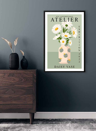 Framed poster of daisies in a patterned vase titled "Daisy Vase - Vincent V" hanging on a dark wall above a dresser.