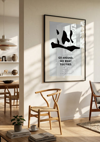 Cycle by KOUYOU KITAZUMI in a black frame in a bright dining room with wooden chairs