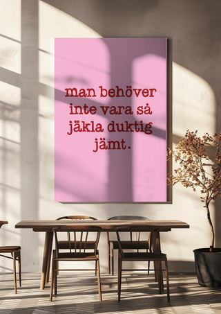 Duktig jämt by Grafik bageri hanging above a wooden dining table in warm sunlight