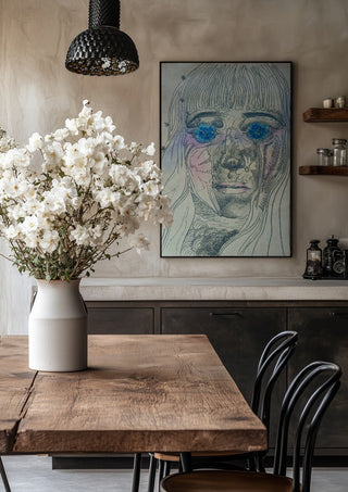 Awe by Alice Ruja in a black frame above a rustic table with white flowers