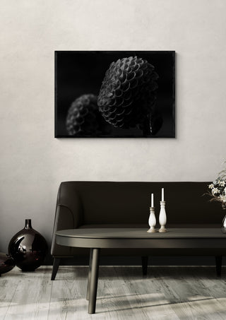 Lunar Bloom II by Guido Lucker framed above a dark sofa beside a candlestick and a vase