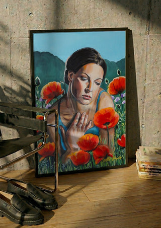 A Moment of Stillness by Nella Hajdu in a black frame leaning against a concrete wall by a steel chair