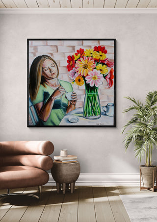 Peaceful Morning by Nella Hajdu in a black frame above a tan leather chair beside a potted plant