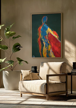 Figure in Green by René J framed above a beige armchair beside a potted plant