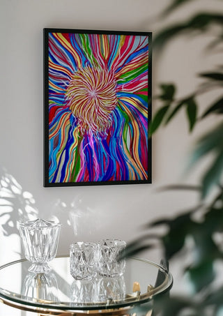 Rainbow Spin by Da Winters in a black frame above a glass table with crystal glassware