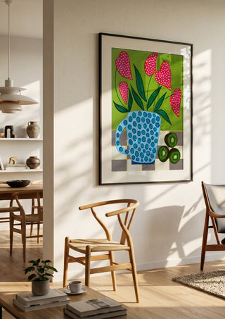 Kiwi My Heart by LGDyrby in a black frame in a bright dining room with wooden chairs