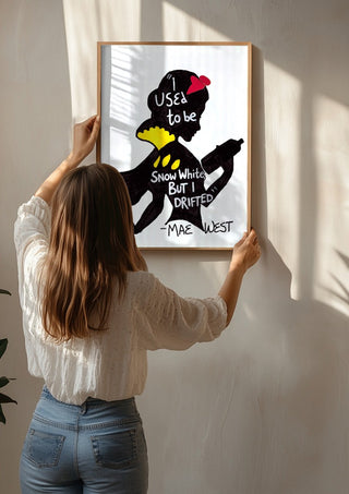 I Used to Be Snow White by Camilla Nilsson being hung on a sunlit wall