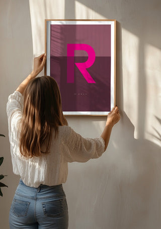 R as in Rebel – Cerise by Quite Nice Prints being hung on a sunlit wall
