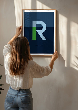 R as in Rebel – Blue by Quite Nice Prints being hung on a sunlit wall