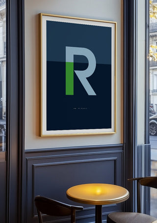 R as in Rebel – Blue by Quite Nice Prints in an oak frame on a panelled cafe wall