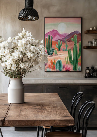 Cactus desert by Ohkimiko in a black frame above a rustic table with white flowers
