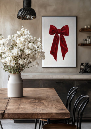 Red velvet bow by Ohkimiko in a black frame above a rustic table with white flowers