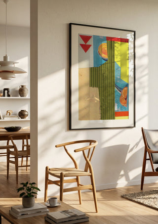 Peach & Mandarin by Kareem Rizk in a black frame in a bright dining room with wooden chairs