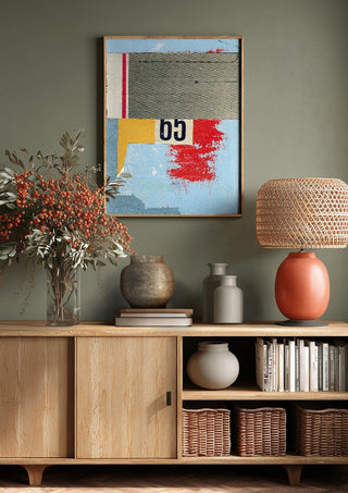 No.65 by Kareem Rizk above a wooden sideboard on a sage green wall