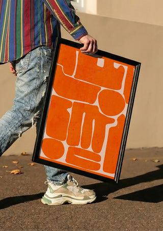 Modern Abstract Minimal Shape 162 by ThingDesign carried in a black frame along a sunny street