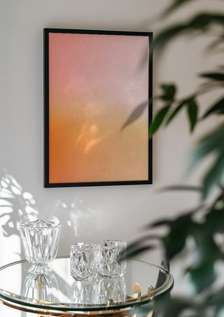 Sunset - cheerful, warm color gradient by Ohkimiko in a black frame above a glass table with crystal glassware