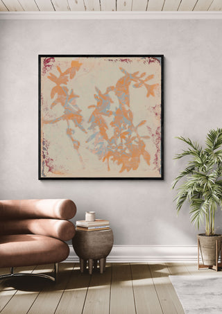 botanical poems 1 by Iris Lehnhardt in a black frame above a leather armchair beside a palm