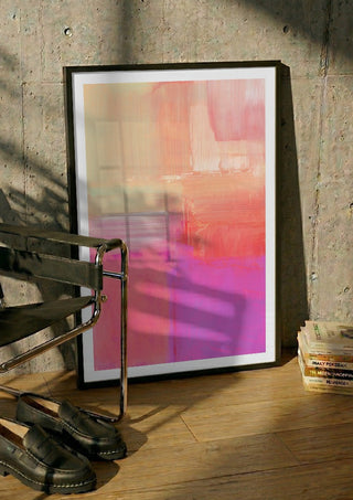 soft atmospheric composition by Iris Lehnhardt in a black frame leaning against a concrete wall by a steel chair