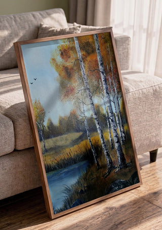 Autumn Birches by the Pond by Lüba in a walnut frame leaning against a grey sofa