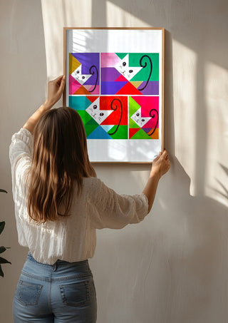 JUST FOUR CATS by NKo being hung on a sunlit wall