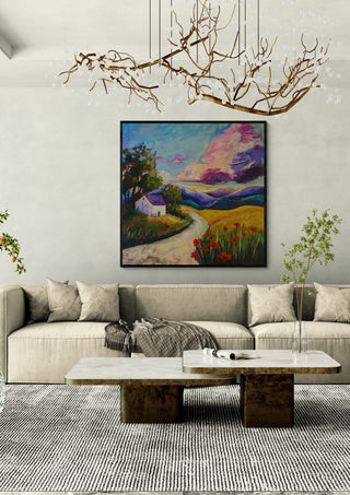A Place to Return To by Evgenia Smirnova in a black frame above a cream sofa under a branch chandelier