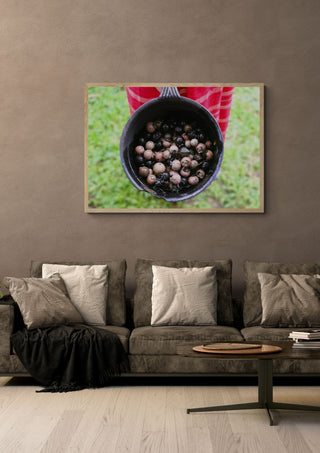 Dye with Ebony by Elefteria in a light oak frame above a grey sofa on a warm brown wall