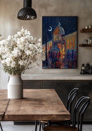 Crescent Moon over the City by Justyna Kopania in a black frame above a rustic table with white flowers