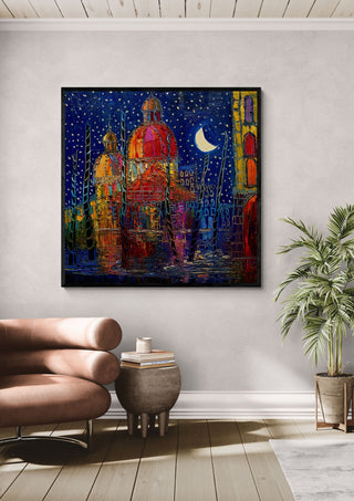 Domes under the Moon by Justyna Kopania in a black frame above a leather armchair beside a palm