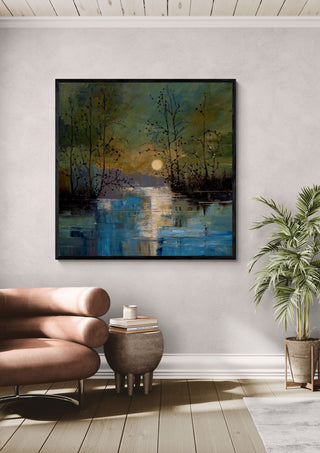 Sun over Still Water by Justyna Kopania in a black frame above a leather armchair beside a palm