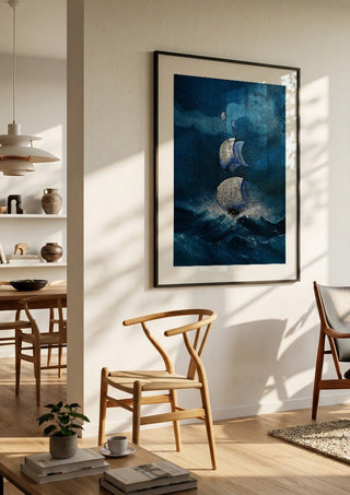 Sails in the Dark Swell by Justyna Kopania in a black frame in a bright dining room with wooden chairs