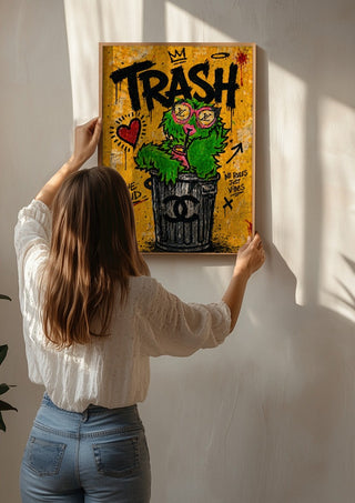 Trash x Grafitti by Decker Studios being hung on a sunlit wall