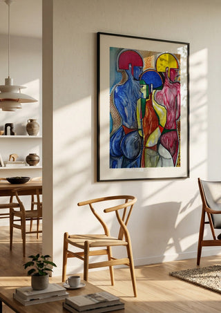 The 3 Graces by inksideme in a black frame in a bright dining room with wooden chairs