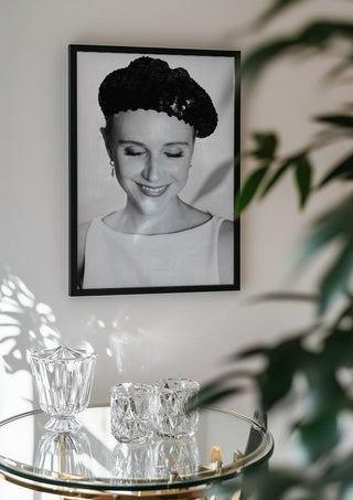 The French girl by Bettinafloorphoto in a black frame above a glass table with crystal glassware