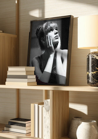The Russian ballet dancer by Bettinafloorphoto in a dark frame on a wooden shelf beside books and a lamp