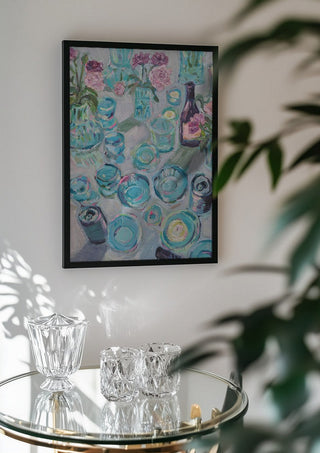 Garden Summer Party by DNF in a black frame above a glass table with crystal glassware