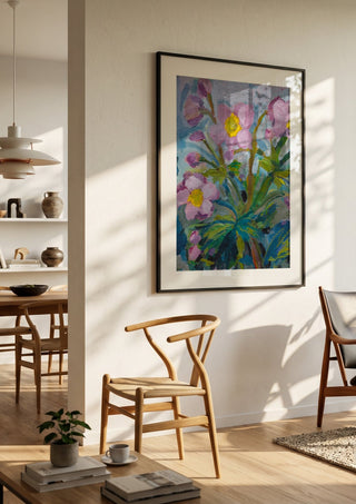Japanese Anemone by DNF in a black frame in a bright dining room with wooden chairs