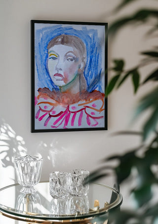 Who's the Clown now by DNF in a black frame above a glass table with crystal glassware