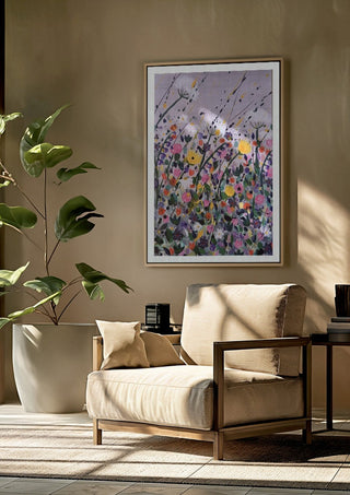Silver street by Rebecca Wright framed above a beige armchair beside a potted plant