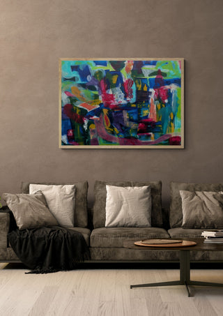 Melange by Janet Bell in a light oak frame on a warm grey wall above a brown sofa