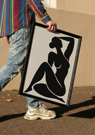 Abstract Black Nude Woman by TimlessArtworks carried in a black frame along a sunny street