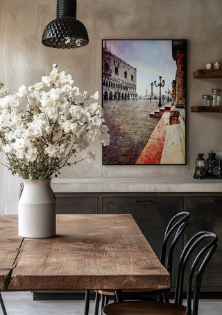 Venezia by Massimo Frascogna in a black frame above a rustic table with white flowers