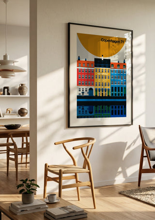 Copenhagen 71 by Bo Lundberg in a black frame in a bright dining room with wooden chairs