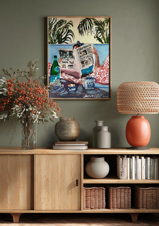 Sunday read at The Phoenicia, Malta by Mariam De Giorgio above a wooden sideboard on a sage green wall