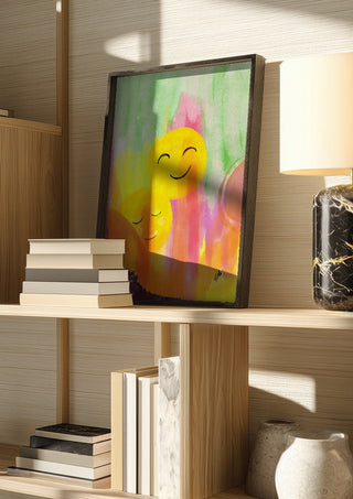 Smile and chill by FridaRit in a dark frame on a wooden shelf beside books and a lamp