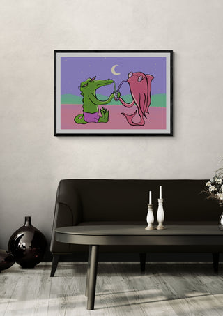 Drinking Buddies by Elisa Albanelli in a black frame on a pale wall above a dark sofa with candlesticks