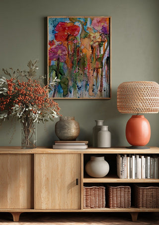 riot garden by hazelart above a wooden sideboard on a sage green wall
