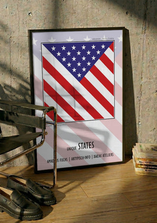 United States - Community Signal by Amadeus Fuchs in a black frame leaning against a concrete wall by a steel chair