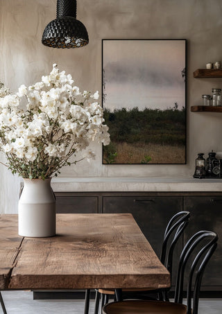 När älvorna dansar by Ljilja Marinic in a black frame above a rustic table with white flowers